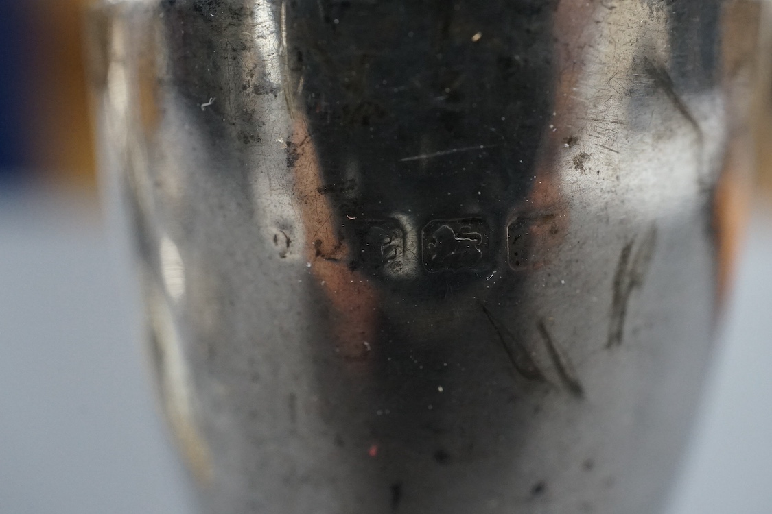 A modern silver wine funnel, with shell thumbpiece, L.J. Millington, Birmingham, 2000, 13.4cm, together with a small silver pedestal cup, three assorted sterling wine labels and three other wine labels including two plat